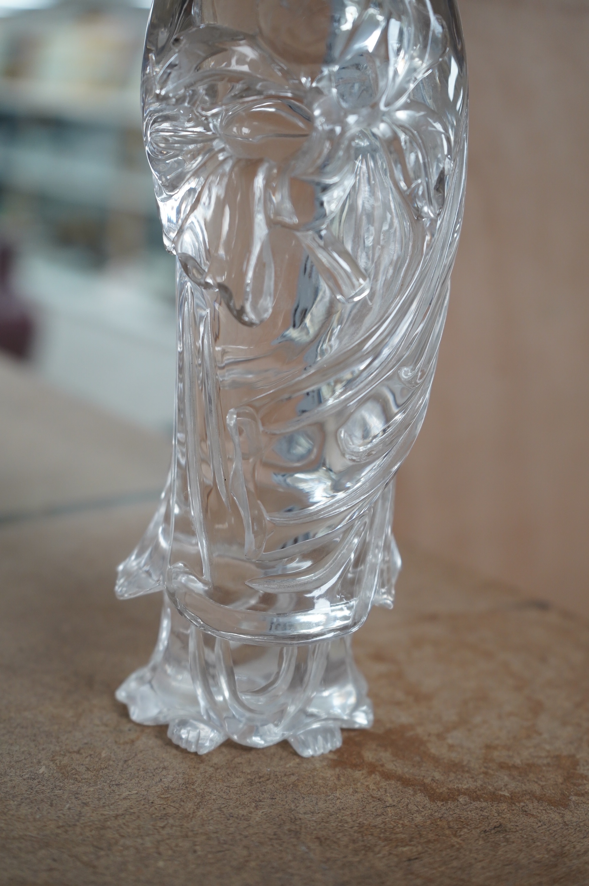 A large Chinese rock crystal figure of a standing lady holding a peony branch, 20th century, 27cm high. Condition - some chips to base